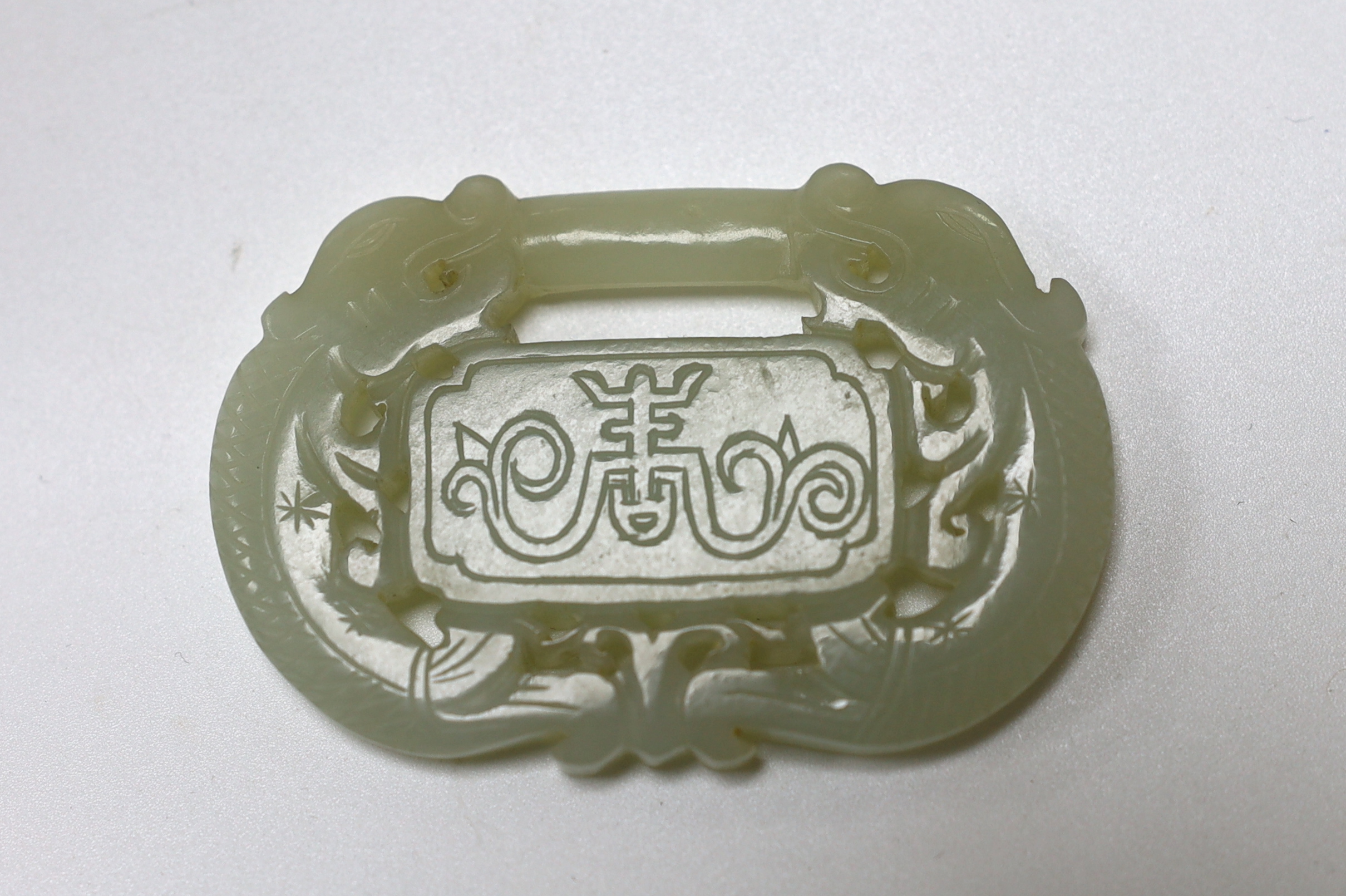 A Chinese pale celadon jade ‘lock’ pendant, 19th century